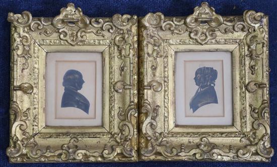 A pair of early Victorian cut and painted paper silhouettes of a lady and gentleman, 3.25 x 2.25in. gesso framed